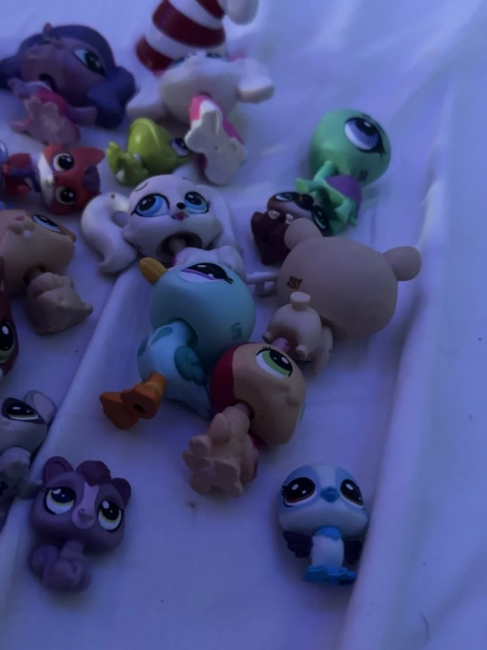 Littlest Pet Shop assorted animal figures in purple, white, brown, green, orange